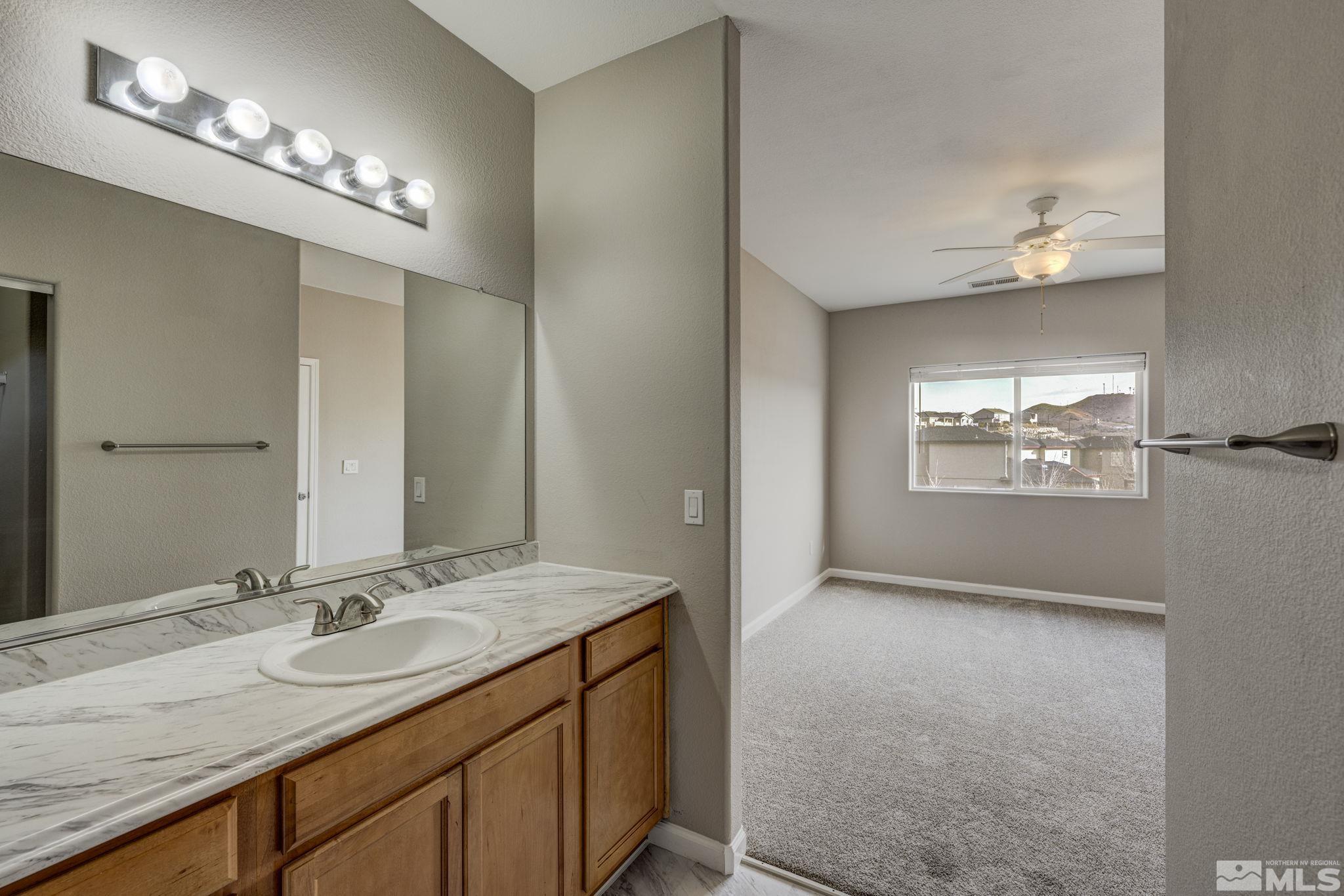 5155 Emery Drive Reno, NV 89506 - Photo 22 of 38 a bathroom with a double vanity sink and a mirror