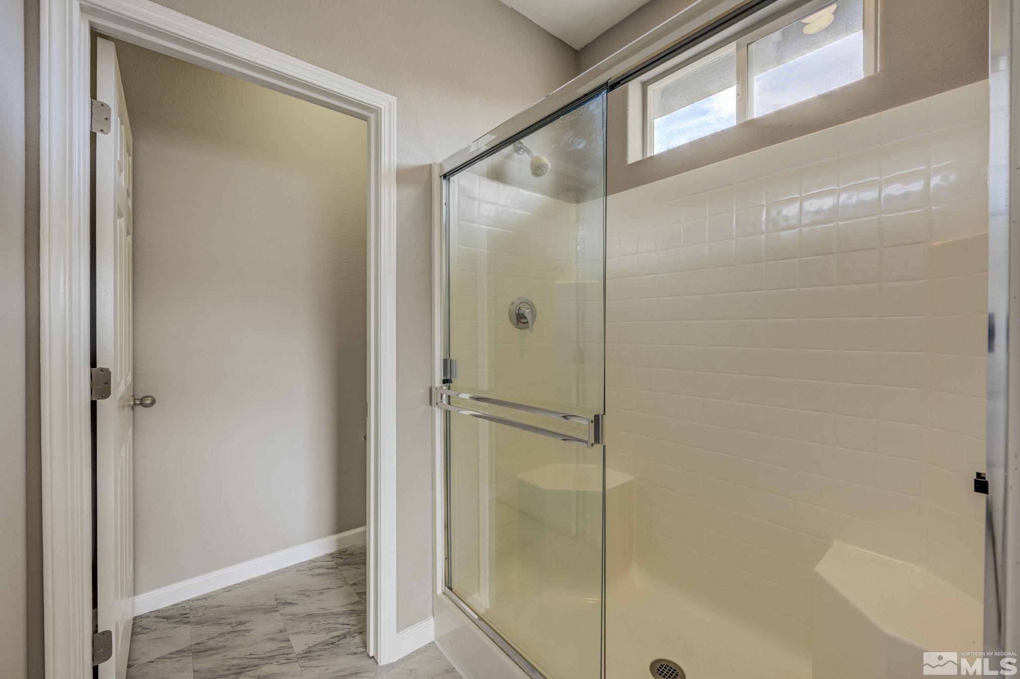 5155 Emery Drive Reno, NV 89506 - Photo 10 of 38 a bathroom with a glass shower door