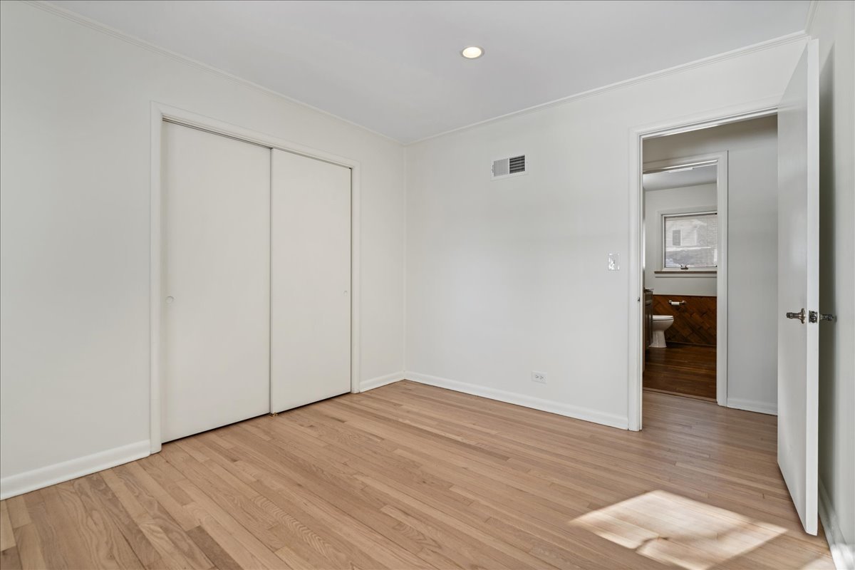 8314 Gross Point Road Morton Grove, IL 60053 - Photo 14 of 28 wooden floor in an empty room