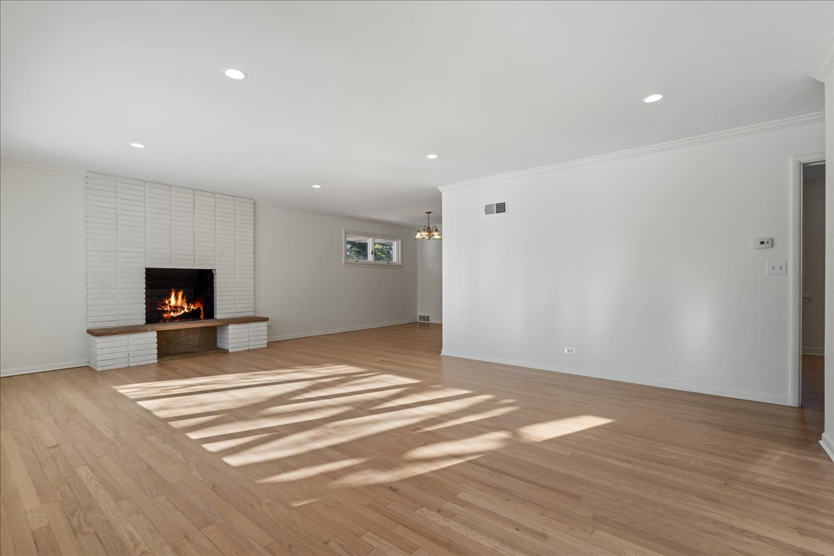 8314 Gross Point Road Morton Grove, IL 60053 - Photo 3 of 28 a view of a livingroom with wooden floor and a flat screen tv