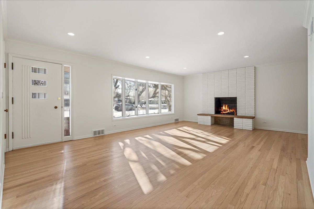 8314 Gross Point Road Morton Grove, IL 60053 - Photo 4 of 28 a view of empty room with wooden floor and window