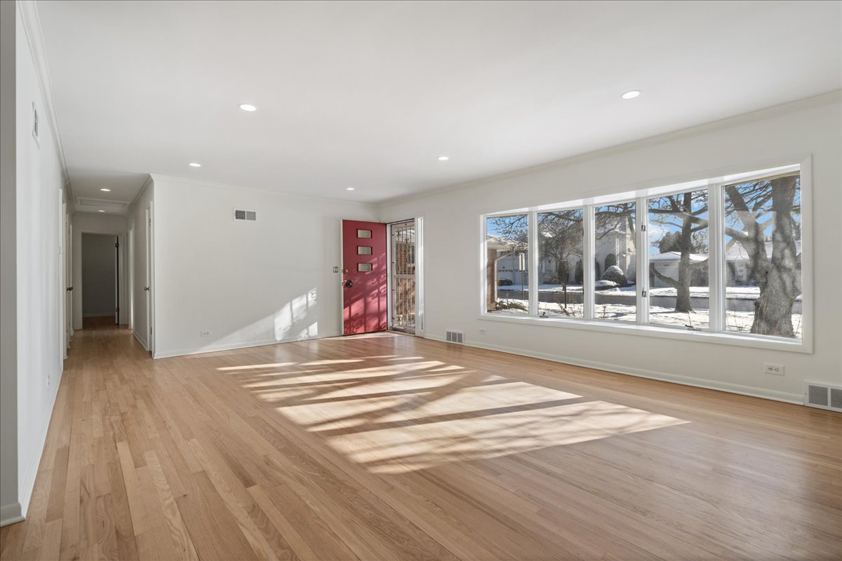 8314 Gross Point Road Morton Grove, IL 60053 - Photo 5 of 28 a view of an empty room with a window and a kitchen