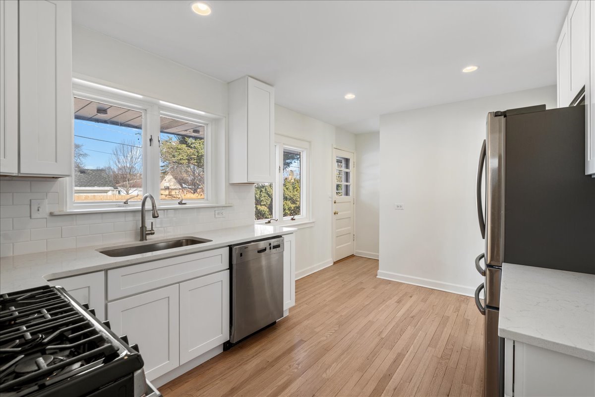 8314 Gross Point Road Morton Grove, IL 60053 - Photo 10 of 28 a kitchen with a sink stove and refrigerator