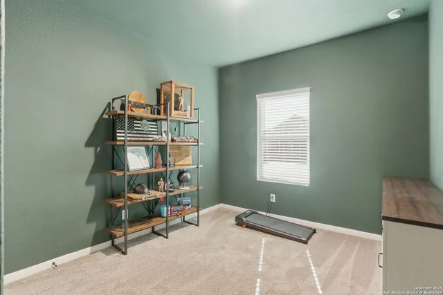 a view of a workspace with furniture and a window