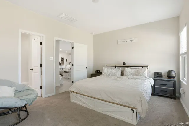 a bedroom with a bed and a couch