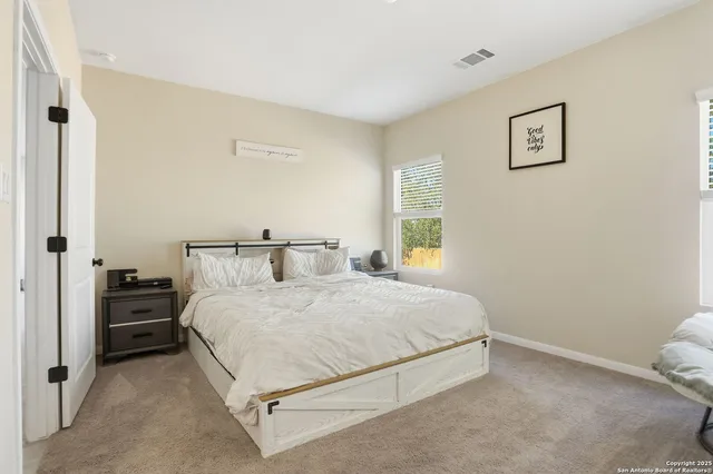 a bedroom with a bed and window