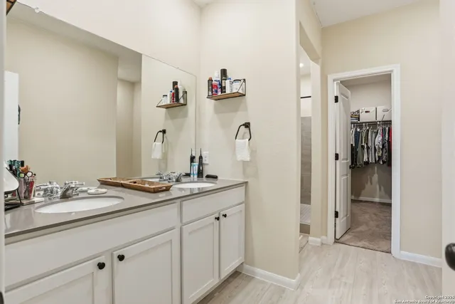 a spacious bathroom with a granite countertop sink and a mirror