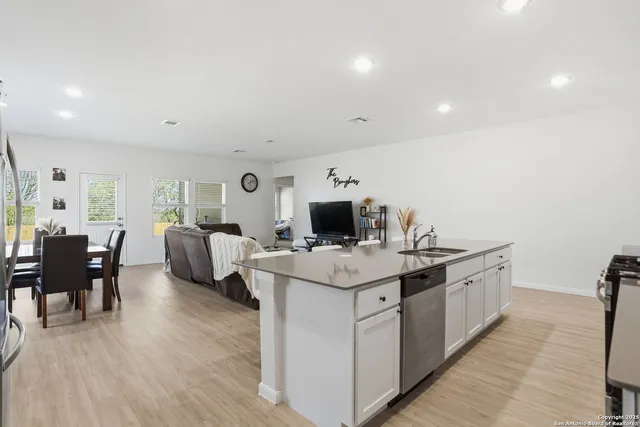 a kitchen with a sink and living room