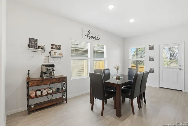 a view of a dining room with furniture and wooden floor