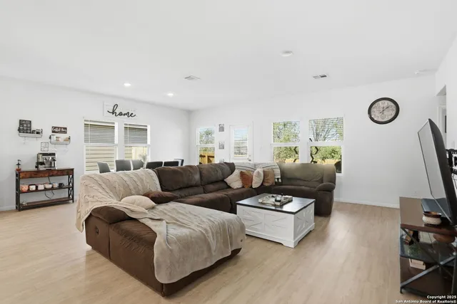 a living room with furniture window and a flat screen tv