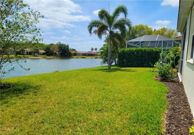 a view of a lake with a house in the background