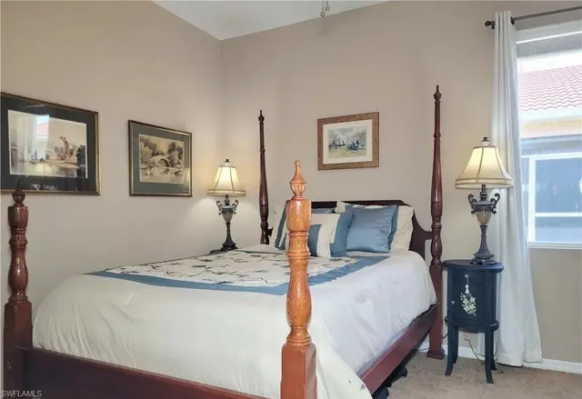 a bedroom with a large bed and a lamp