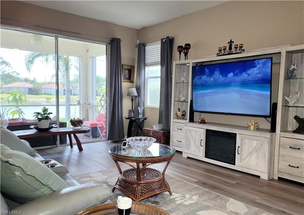 2190 Summersweet Drive Alva, FL 33920 - Photo 2 of 14 a living room with fireplace furniture and a flat screen tv