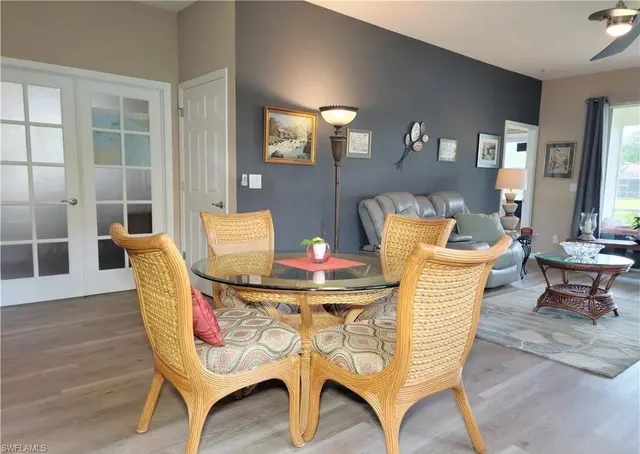 a dining room with furniture and wooden floor