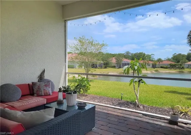 a view of a swimming pool with a couches in a patio