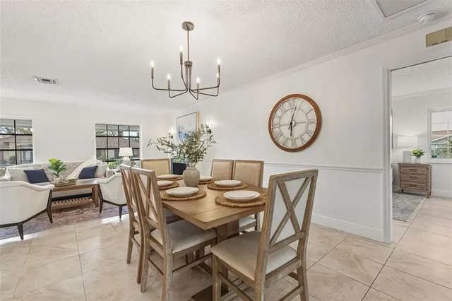 a view of a dining room with furniture and a chandelier