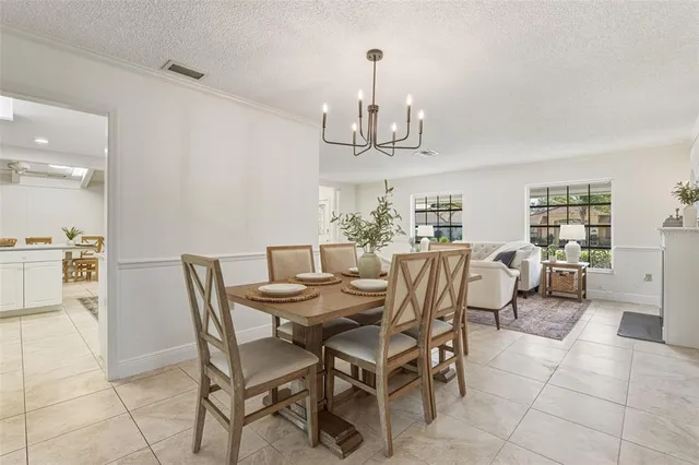 a kitchen with a refrigerator and white cabinets