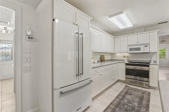 a living room with furniture large window and wooden floor