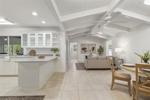 a living room with furniture a table and a large window