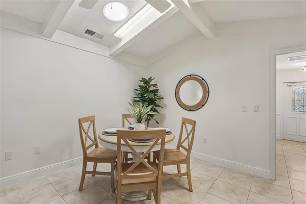 a living room with furniture and kitchen view