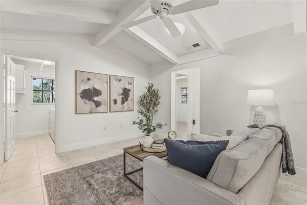 a spacious bedroom with a large bed and a chandelier