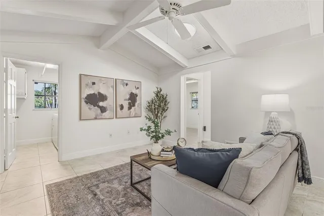 a spacious bedroom with a large bed and a chandelier