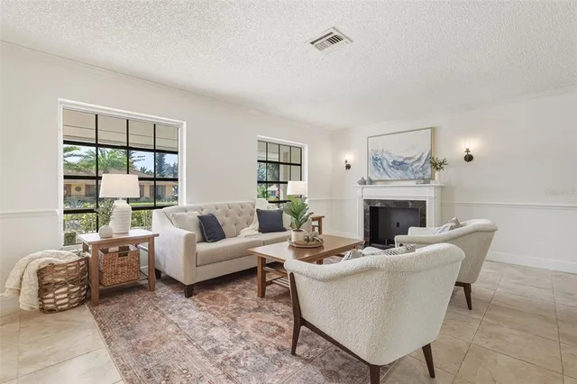 a living room with furniture a fireplace and a table