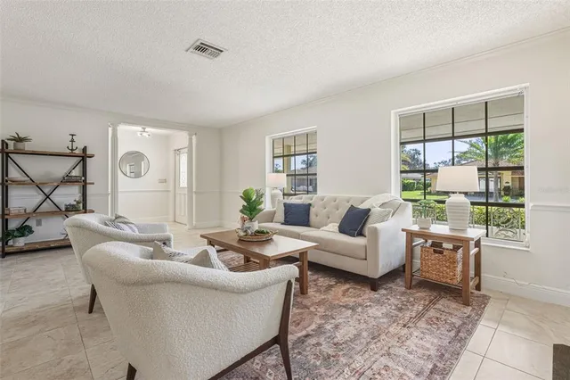 a living room with furniture a clock and a fireplace