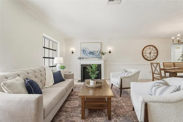 a living room with furniture and fireplace