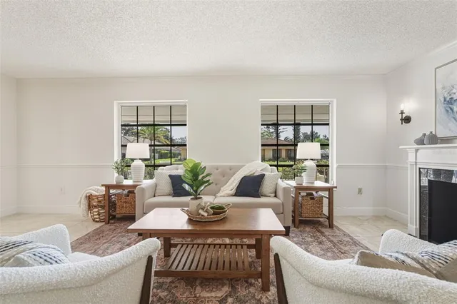 a view of a dining room with furniture and a chandelier