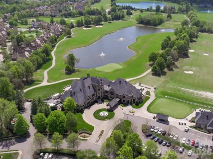 an aerial view of a house with yard swimming pool and outdoor seating