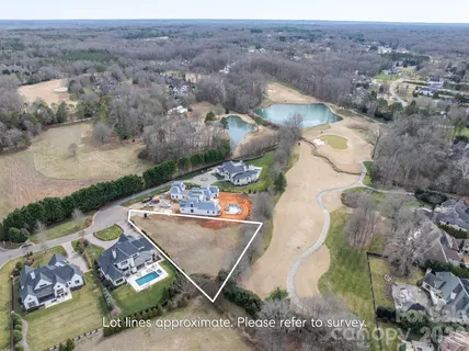 an aerial view of a house with a mountain