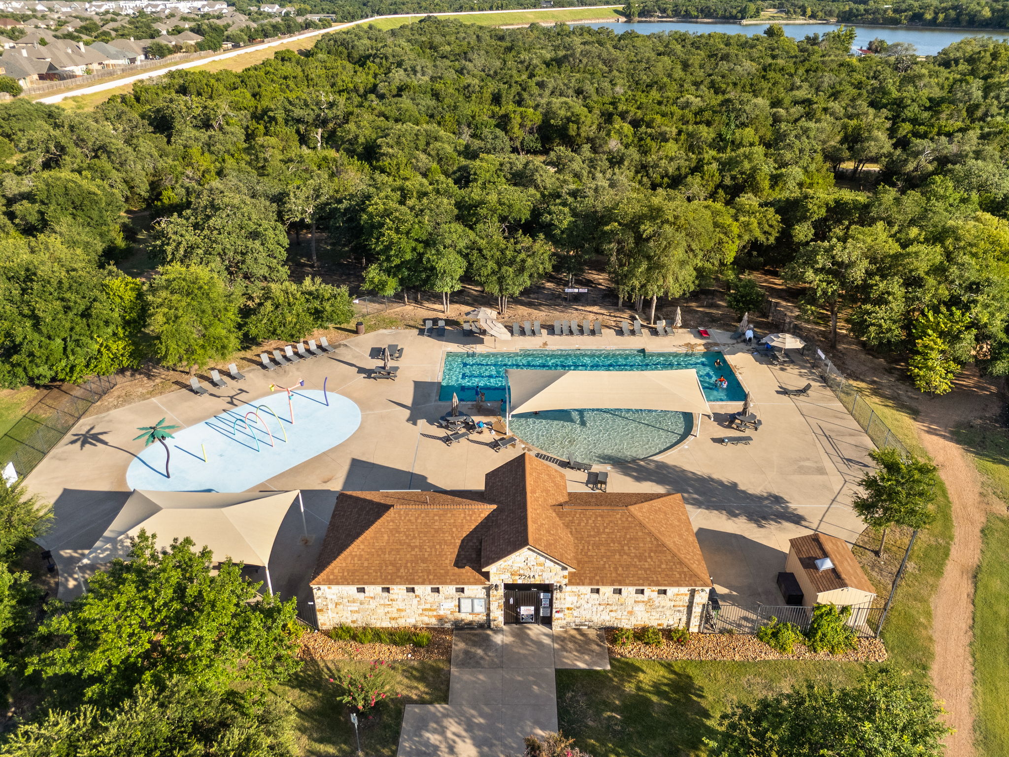 2400 Leonards Pass Leander, TX 78641 - Photo 39 of 40 A vibrant community hub featuring a pristine pool and recreational splash pad.