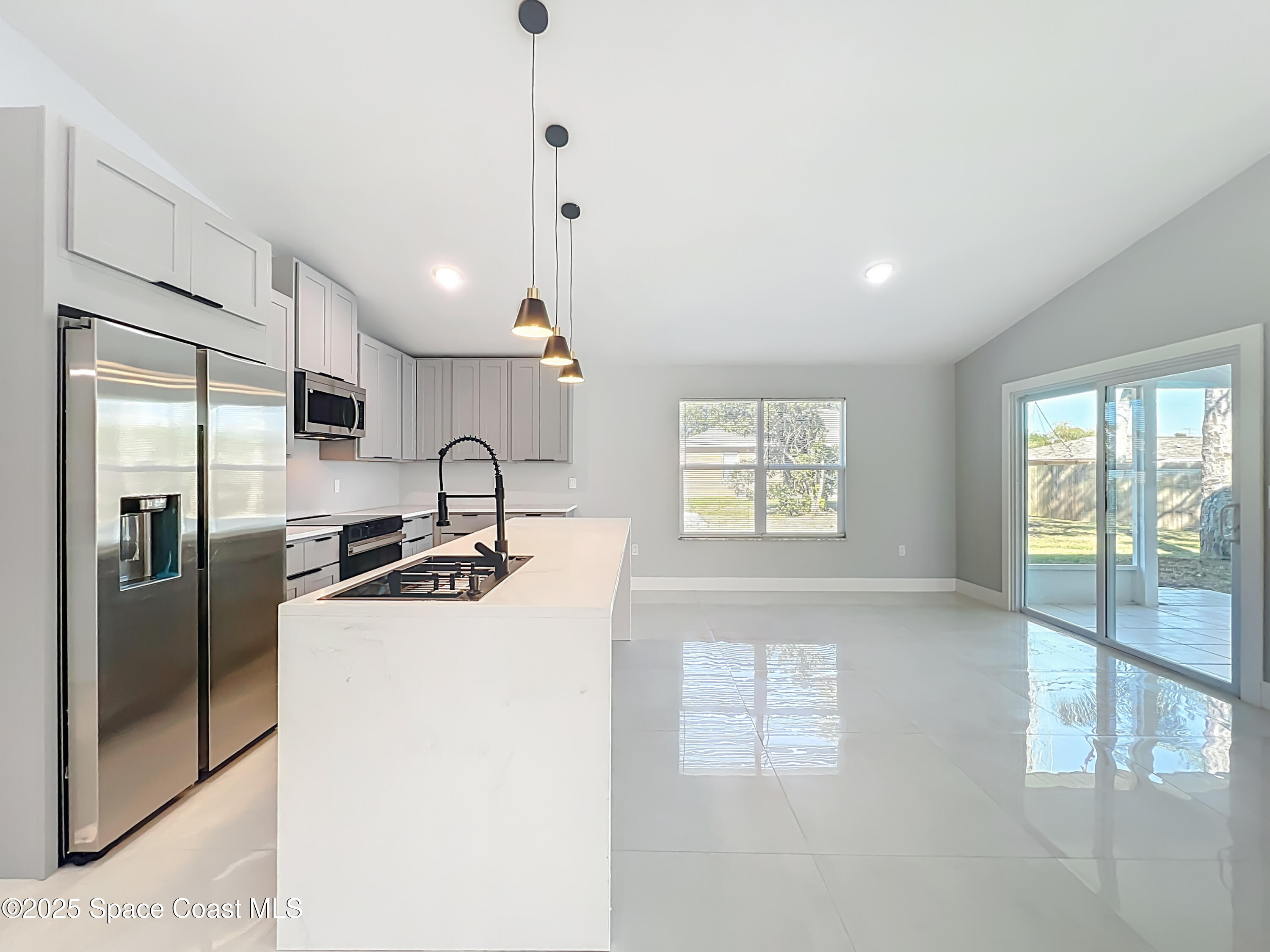 1911 Academy Street Northeast Palm Bay, FL 32905 - Photo 15 of 65 a kitchen with stainless steel appliances granite countertop a sink a stove and a refrigerator