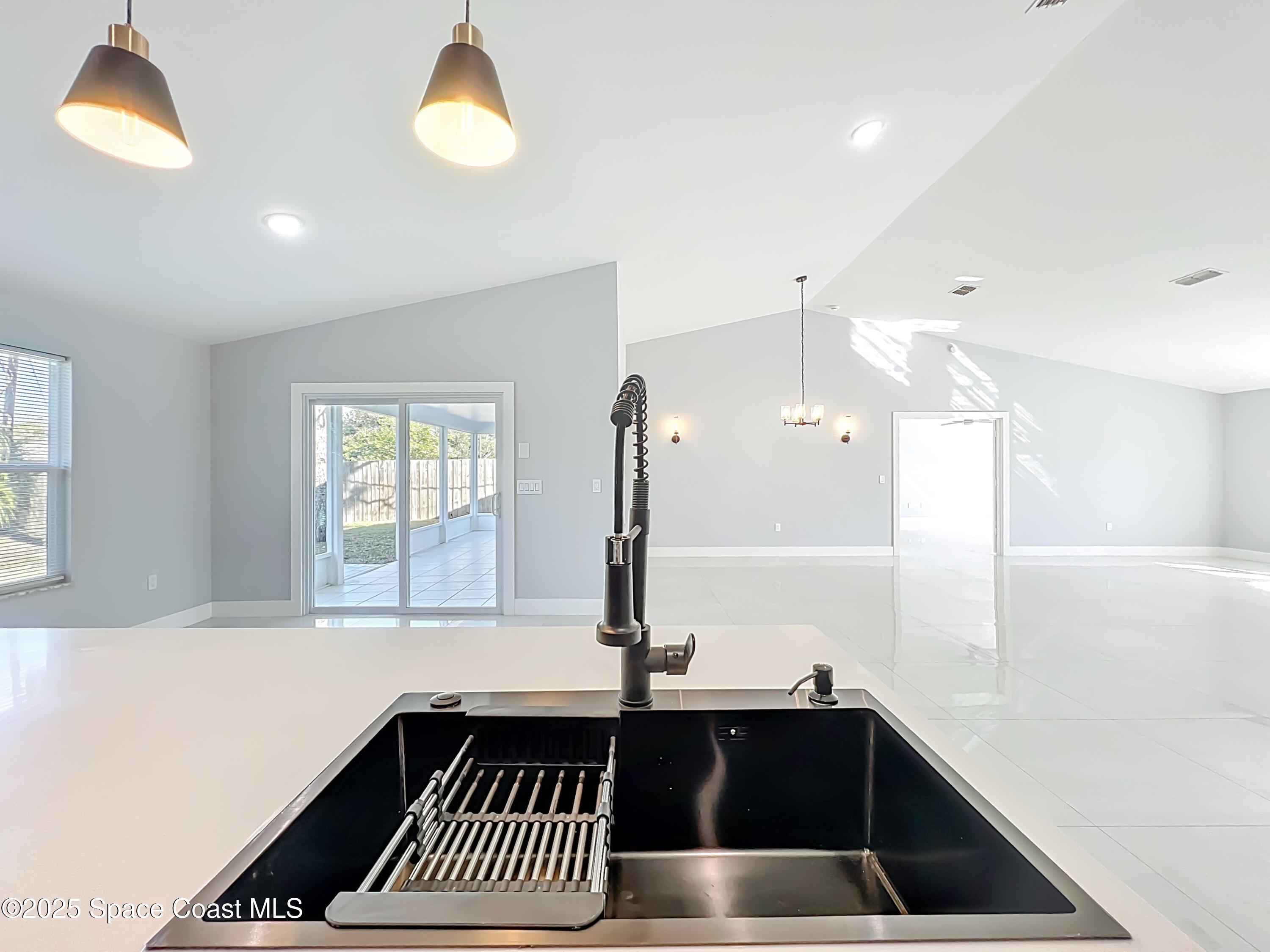 1911 Academy Street Northeast Palm Bay, FL 32905 - Photo 17 of 65 a kitchen with a sink and a window