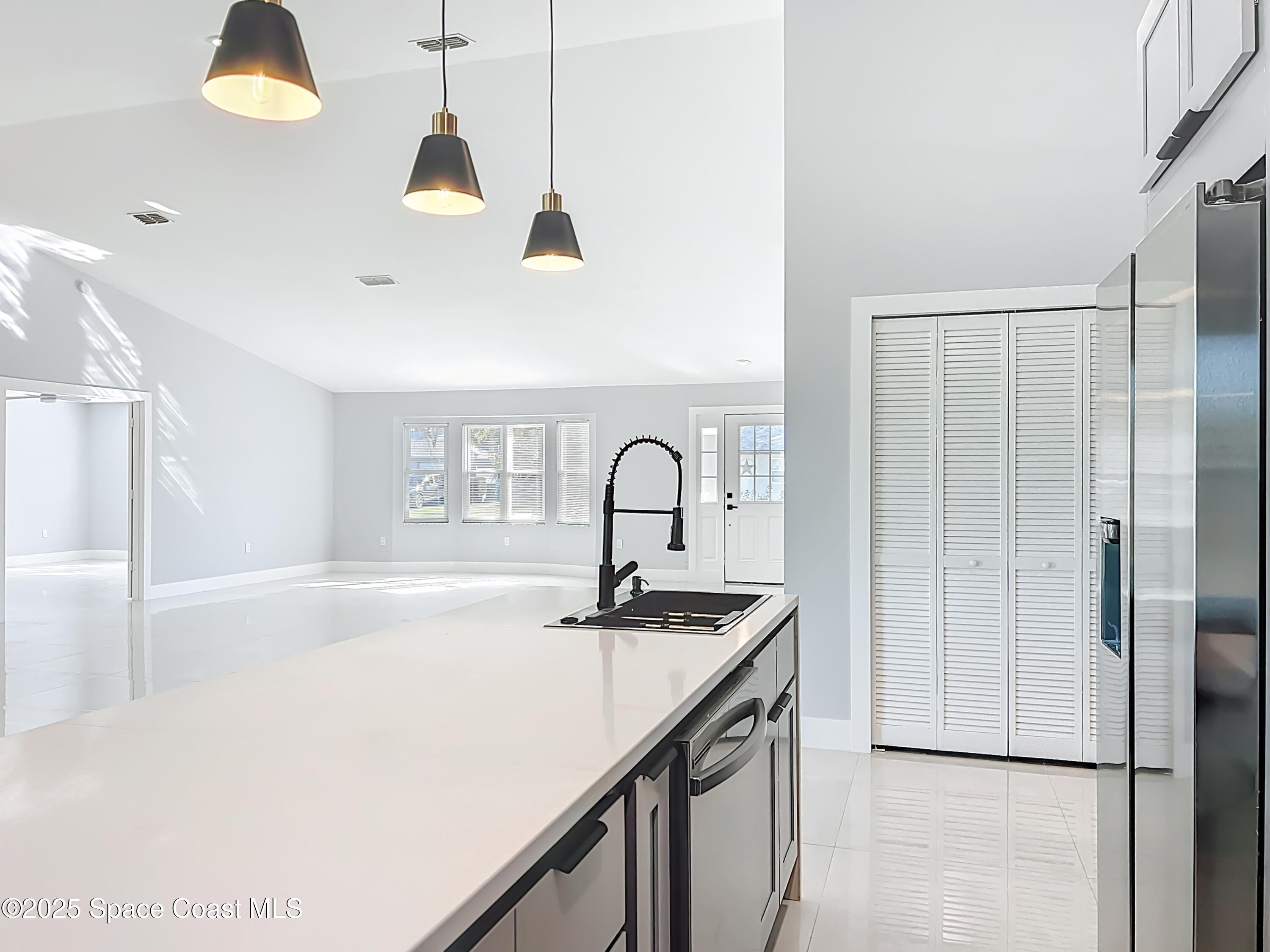 1911 Academy Street Northeast Palm Bay, FL 32905 - Photo 19 of 65 a kitchen with a sink a counter top space and stainless steel appliances