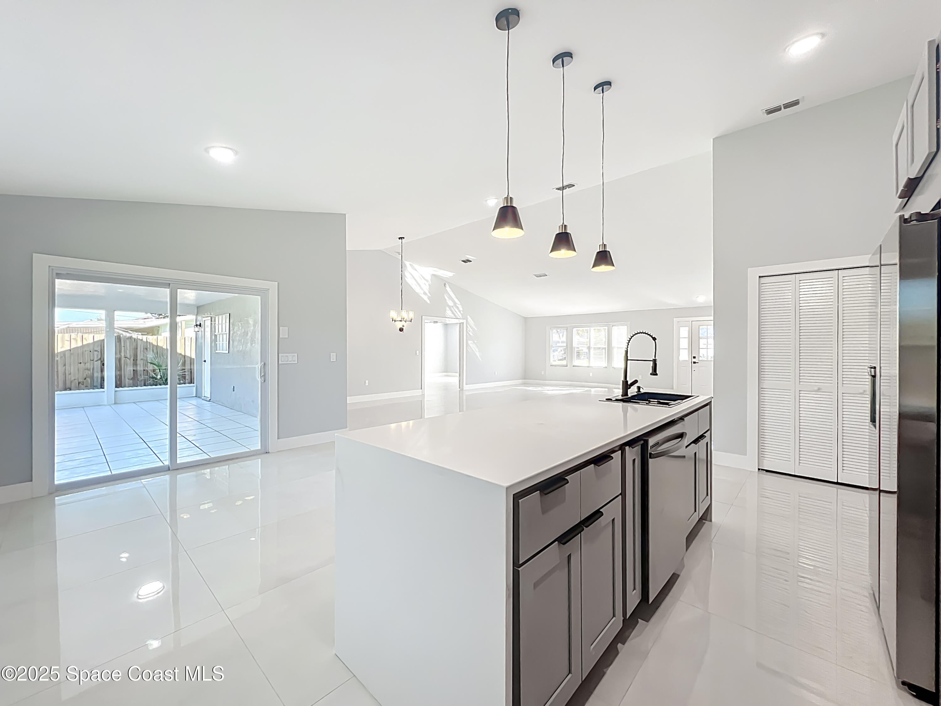 1911 Academy Street Northeast Palm Bay, FL 32905 - Photo 20 of 65 a kitchen with stainless steel appliances kitchen island a large island in the center