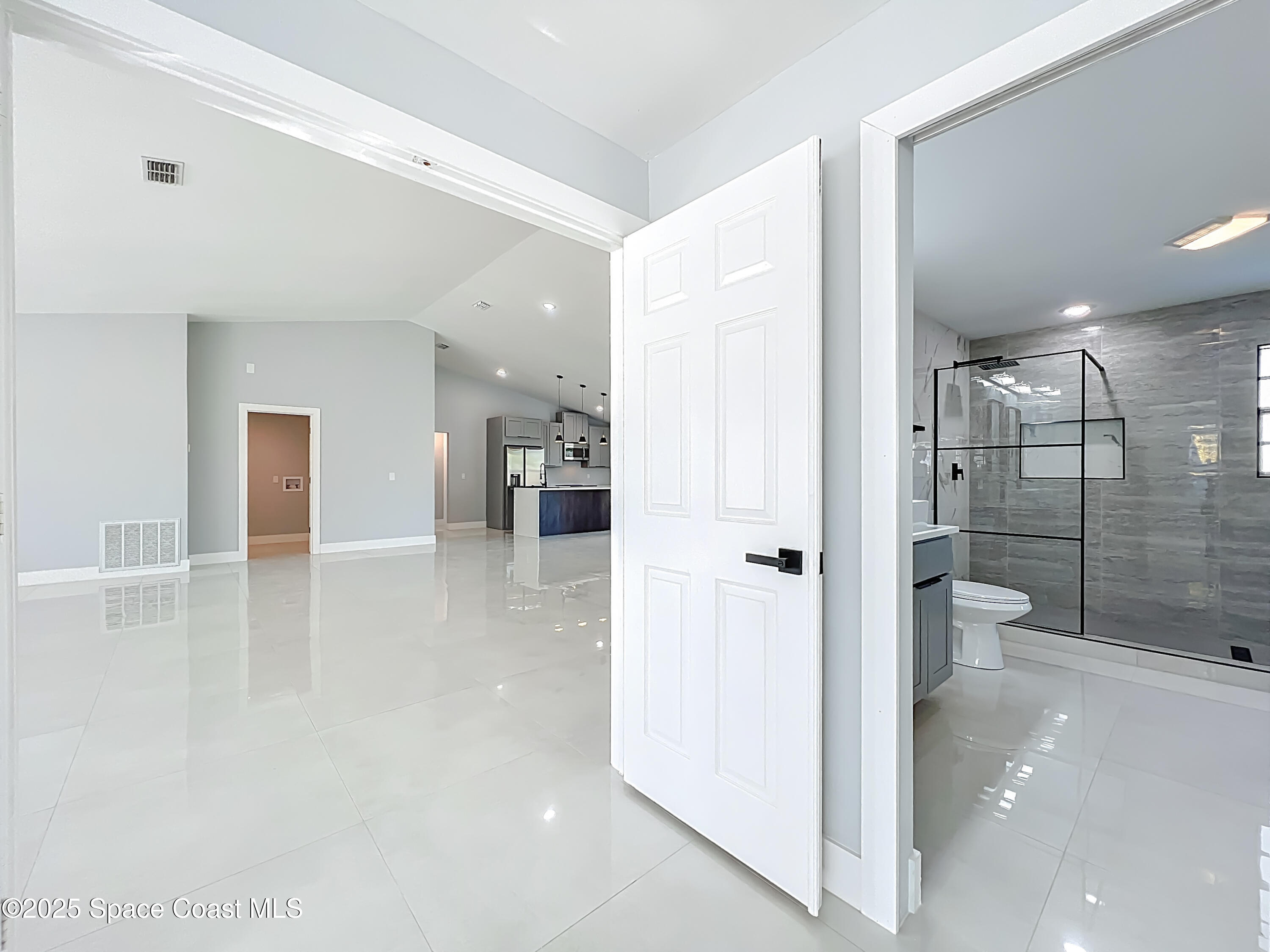 1911 Academy Street Northeast Palm Bay, FL 32905 - Photo 24 of 65 a bathroom with a glass shower door