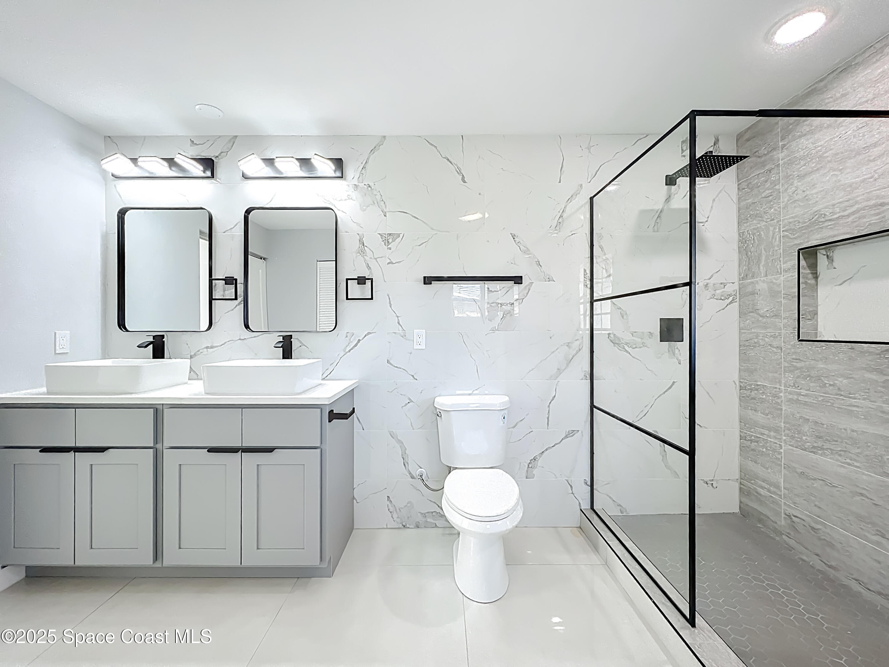 1911 Academy Street Northeast Palm Bay, FL 32905 - Photo 29 of 65 a bathroom with a sink toilet and shower