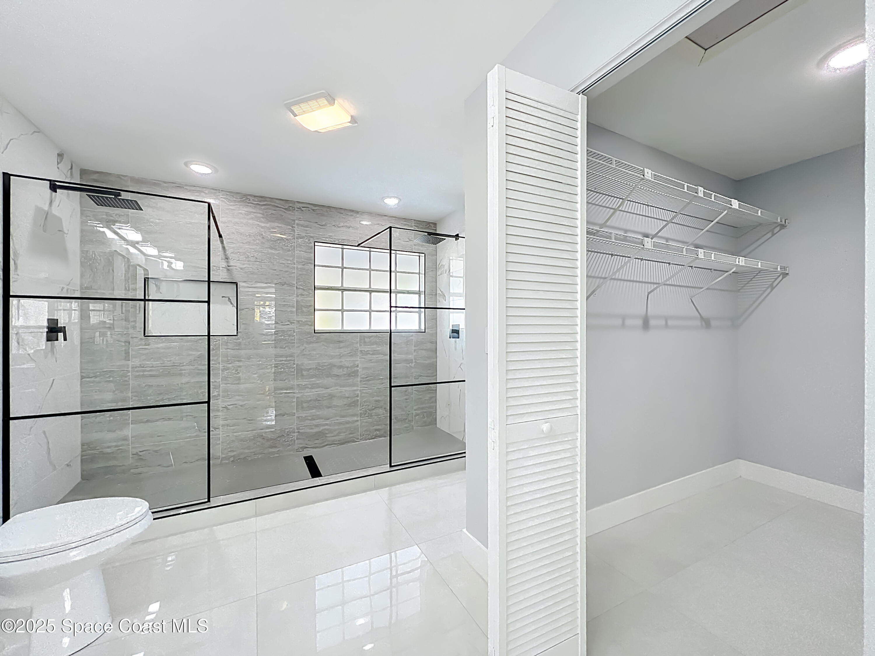 1911 Academy Street Northeast Palm Bay, FL 32905 - Photo 34 of 65 a bathroom with a shower and toilet