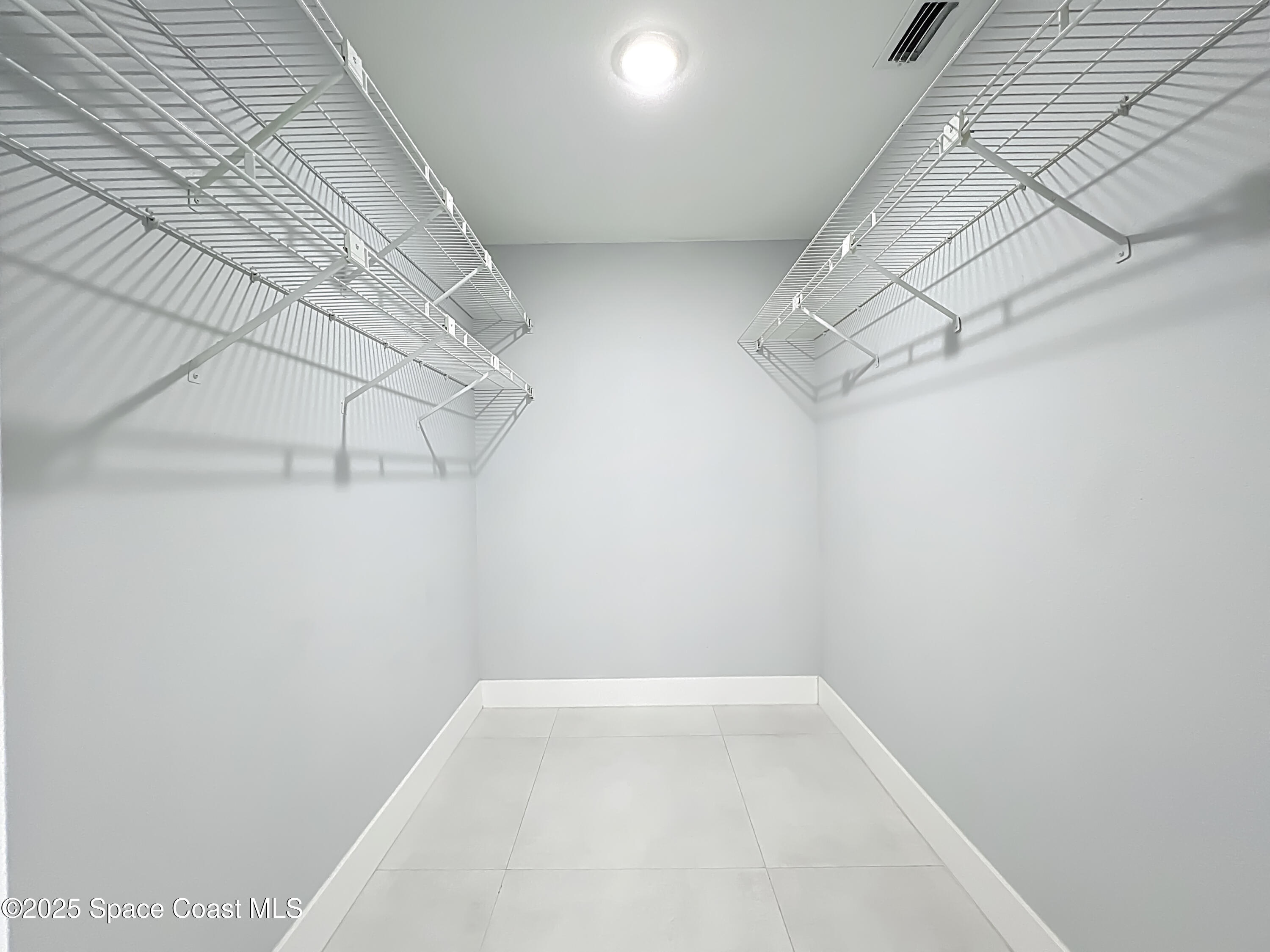 1911 Academy Street Northeast Palm Bay, FL 32905 - Photo 35 of 65 a view of a room with racks on the wall