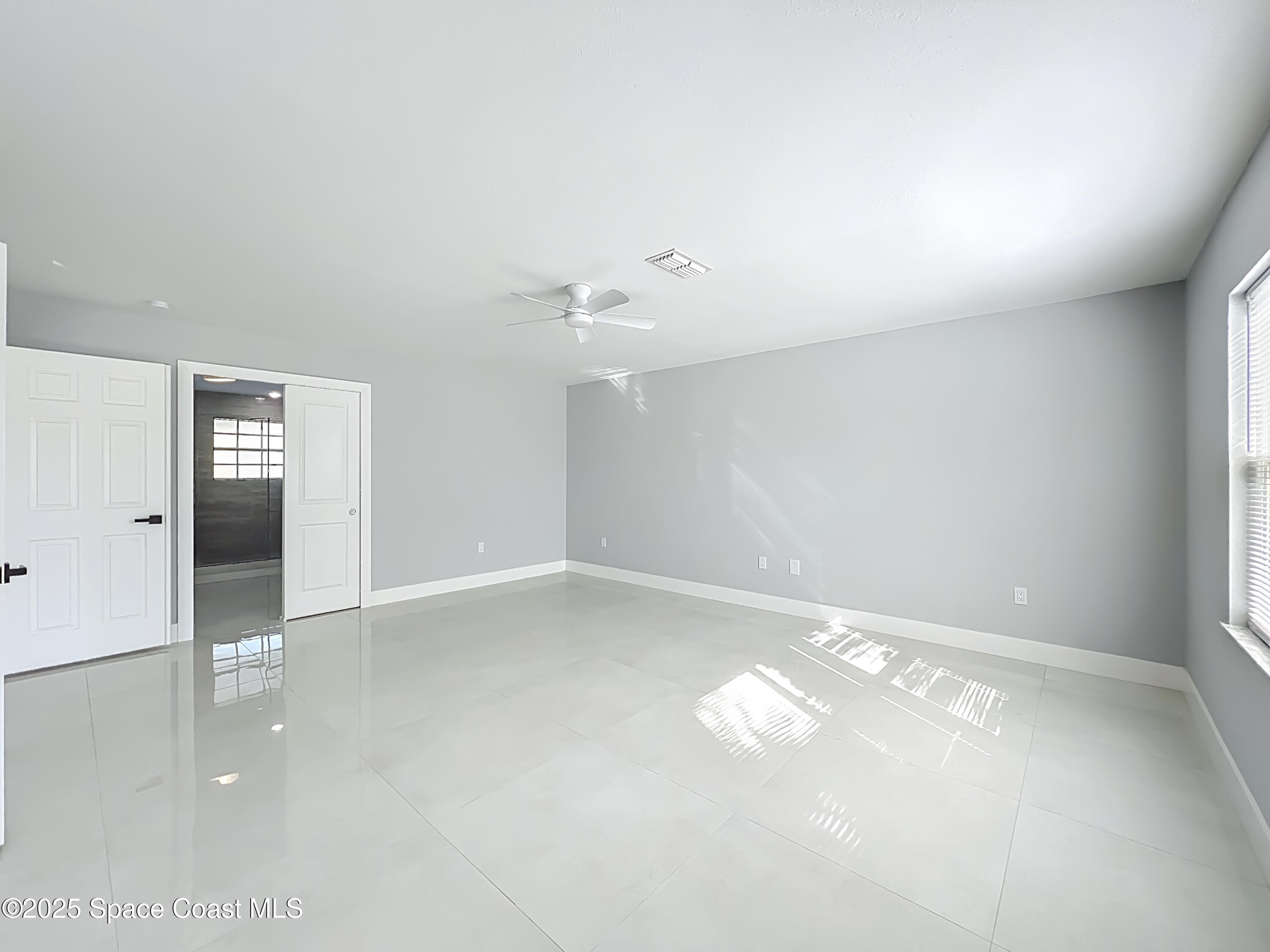 1911 Academy Street Northeast Palm Bay, FL 32905 - Photo 38 of 65 en empty room with windows and closet