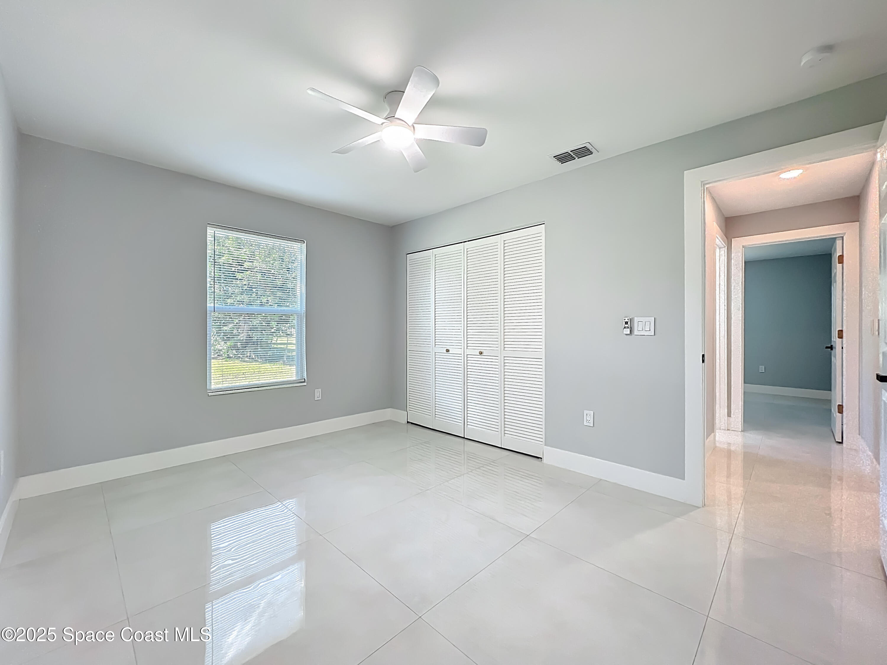 1911 Academy Street Northeast Palm Bay, FL 32905 - Photo 42 of 65 a view of an empty room with window and closet area