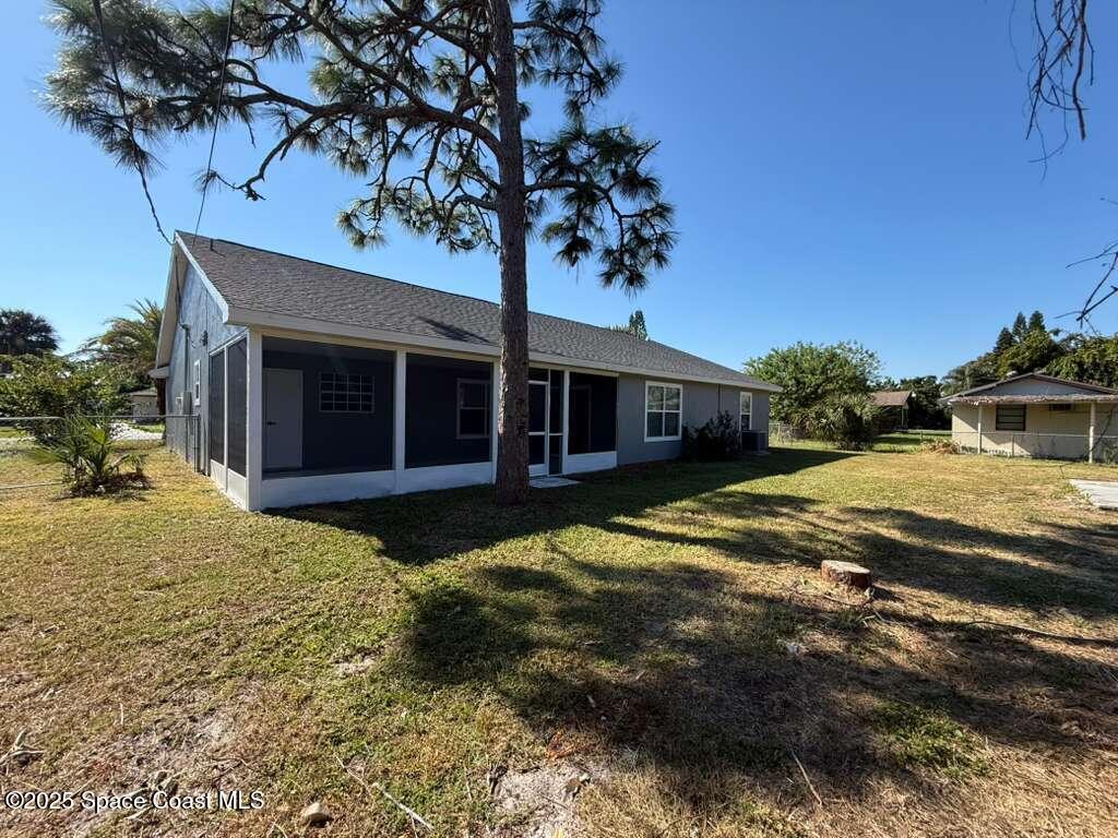 1911 Academy Street Northeast Palm Bay, FL 32905 - Photo 63 of 65 a front view of a house with garden