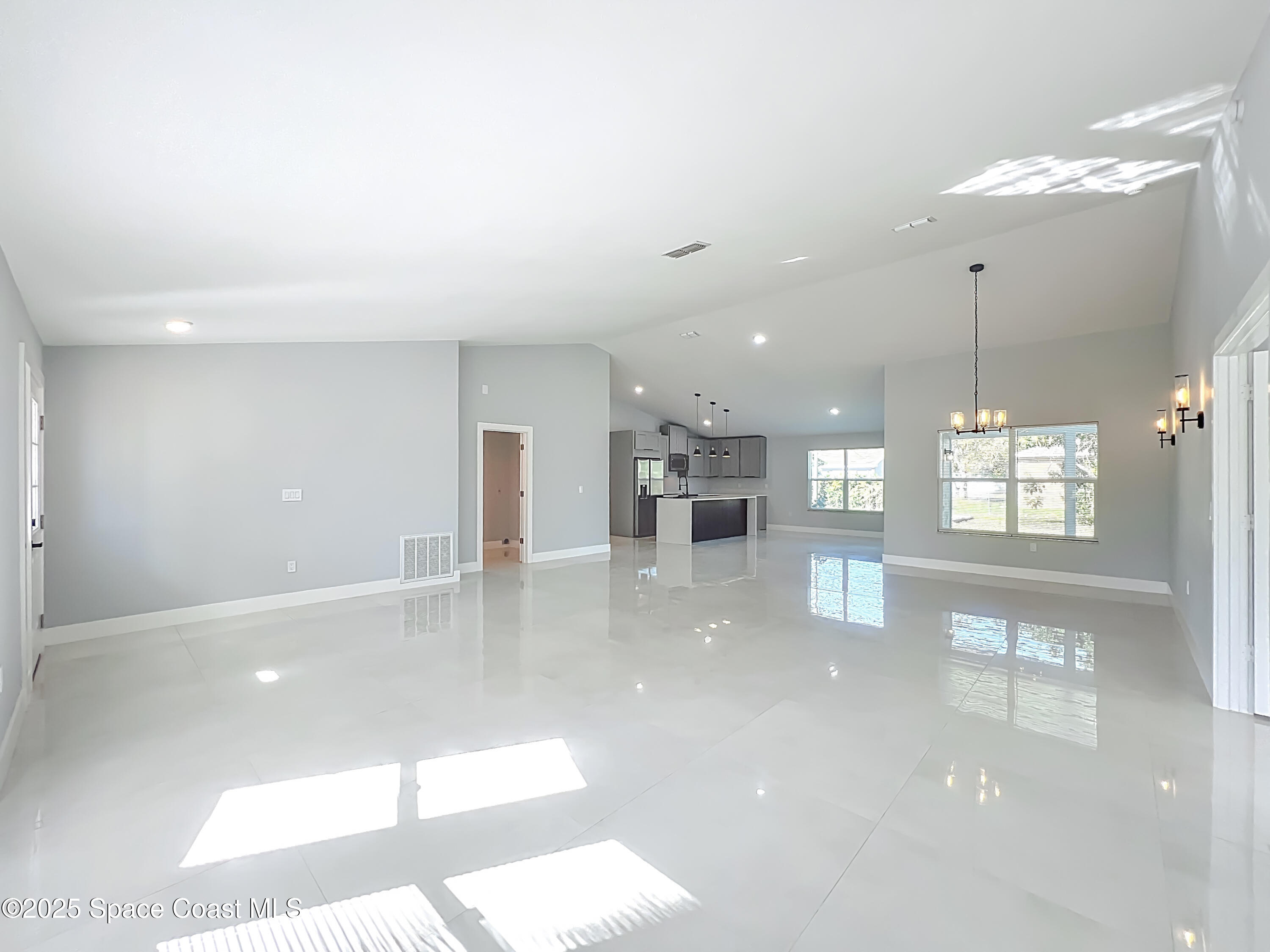 1911 Academy Street Northeast Palm Bay, FL 32905 - Photo 7 of 65 a view of a living room and kitchen with a large window