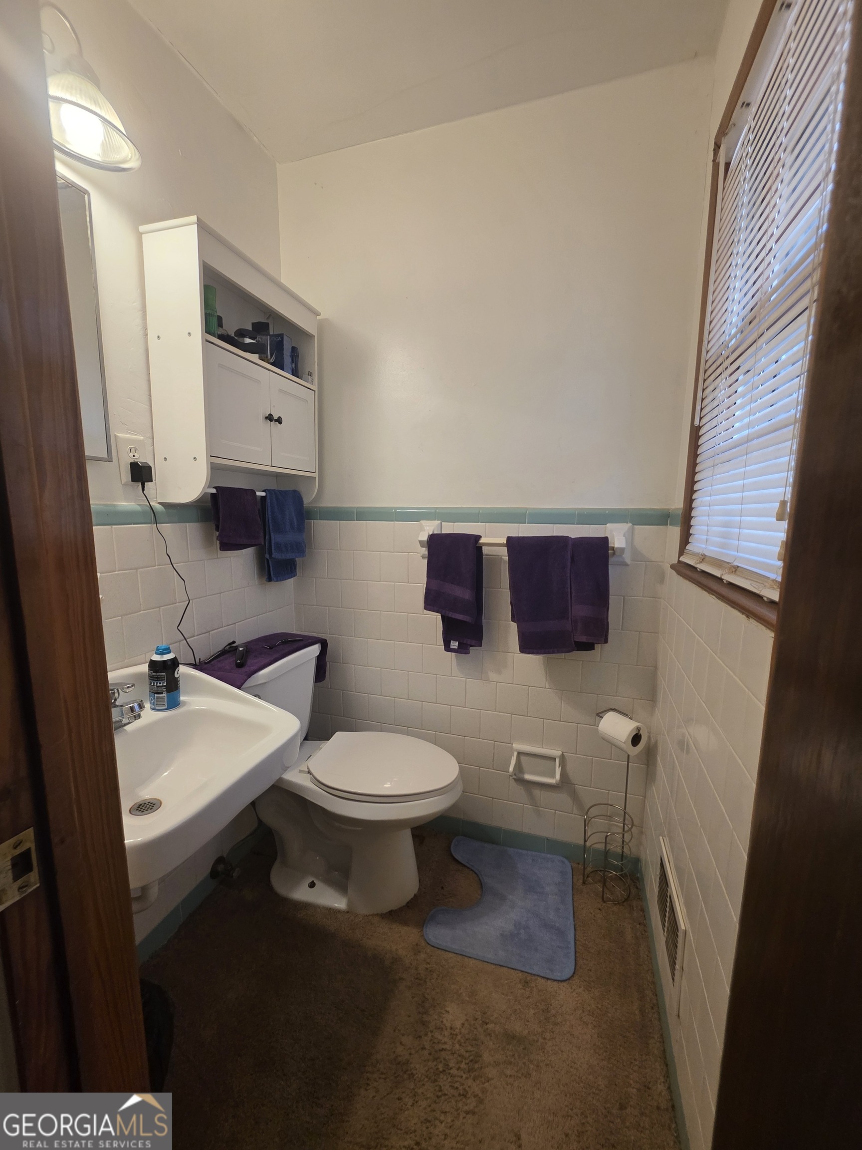115 Burnside Street Jonesboro, GA 30236 - Photo 11 of 19 a bathroom with a toilet a sink and mirror