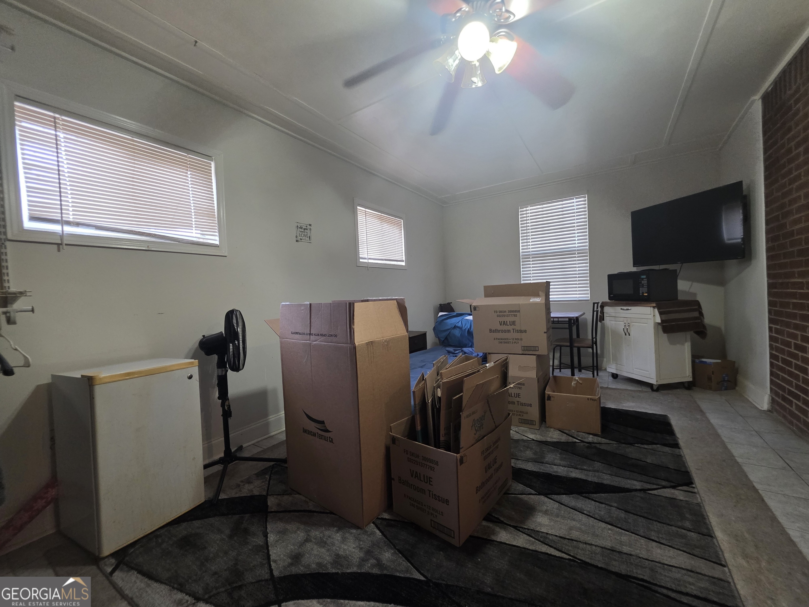 115 Burnside Street Jonesboro, GA 30236 - Photo 17 of 19 a view of a workspace with furniture and a flat screen tv