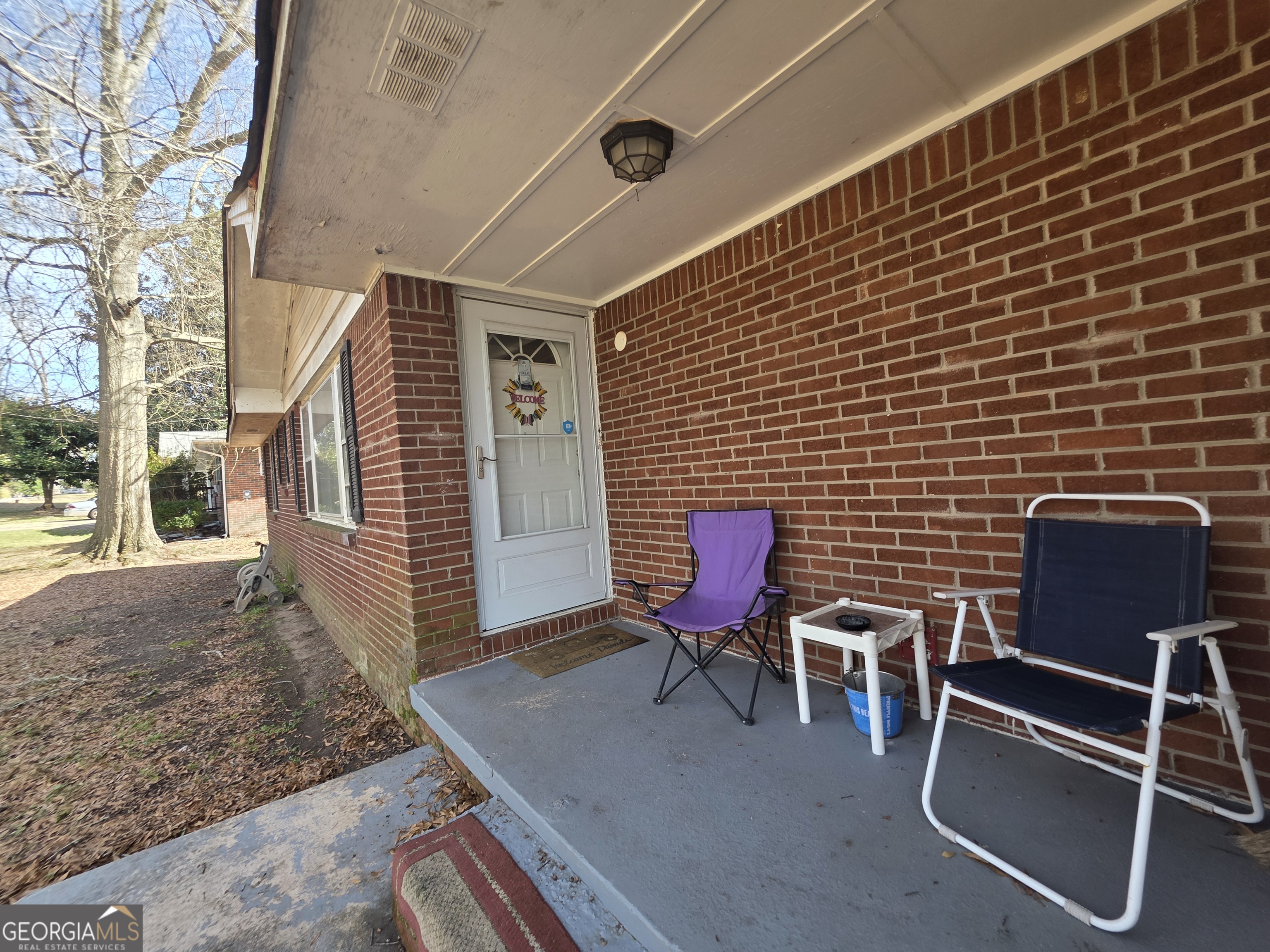 115 Burnside Street Jonesboro, GA 30236 - Photo 3 of 19 a view of a chairs and table in the backyard