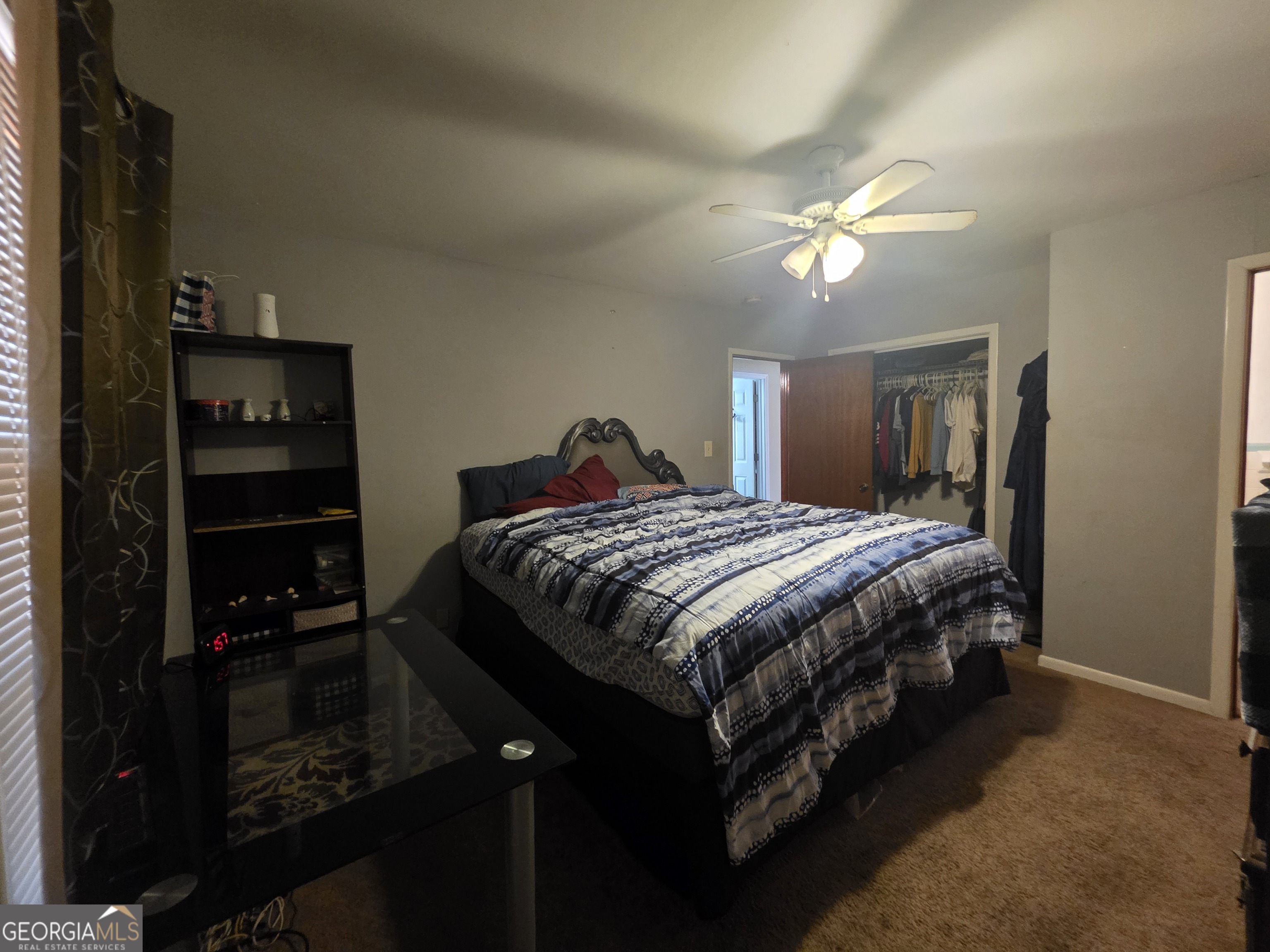 115 Burnside Street Jonesboro, GA 30236 - Photo 8 of 19 a bedroom with a bed and a chandelier