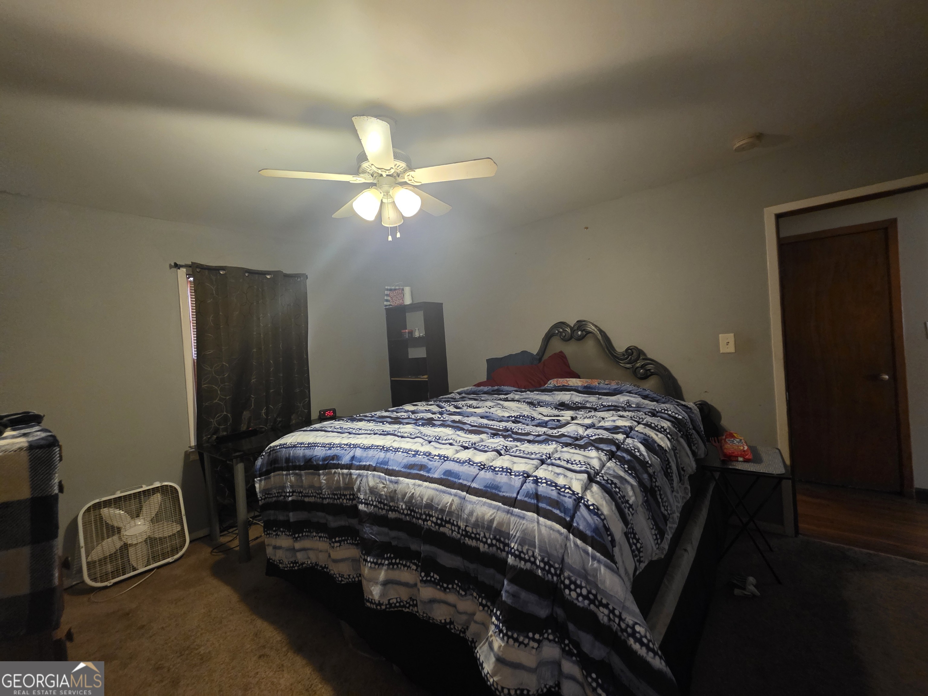 115 Burnside Street Jonesboro, GA 30236 - Photo 10 of 19 a bedroom with a bed and a chandelier